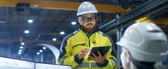 Engineer with hardhat and tablet